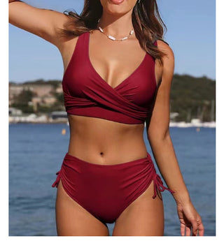 Stylish Crimson Swimsuit - Chic wrap-around design in rich red with sleek, tailored fit showcasing the model's flattering curves and trendy aesthetic near the seaside.