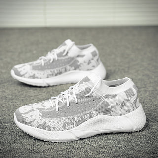 White and gray camouflage-patterned jogging sneakers on a textured surface