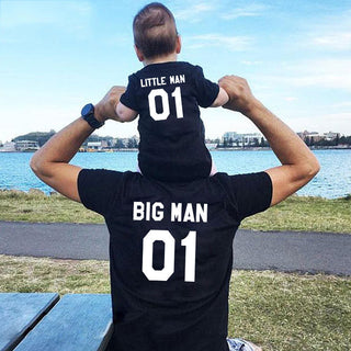 Family Matching Fashion: Big and Little Man T-Shirt Set showcasing a loving bond between father and son at the scenic seaside.