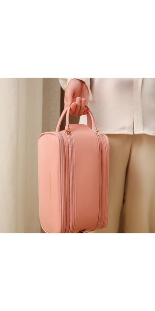 Stylish pink cosmetic bag with triple zipper compartments, ideal for storing and organizing skincare products and makeup. Versatile and portable design for convenient storage and travel.