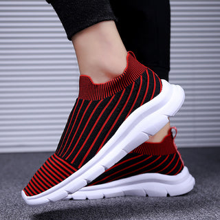 Vibrant red and black striped jogging sneakers with a sleek, knit upper and a thick, white sole for comfortable athletic wear.