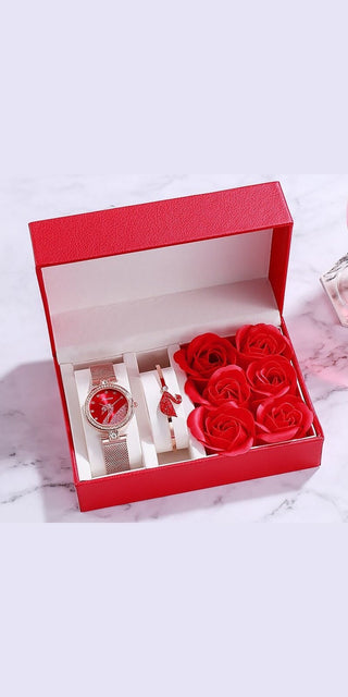 Elegant Valentine's Day gift set: Luxury women's watch, red roses in a stylish red box on a marble background.