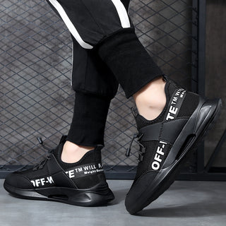 Stylish black and white sneakers with distinctive branding displayed on the upper. The sneakers are set against a dark background, showcasing their modern, sporty design.