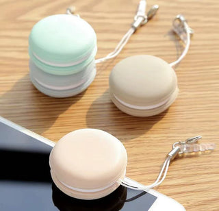 Mint and white macaron-shaped screen cleaners for mobile devices, displayed on a wooden surface.