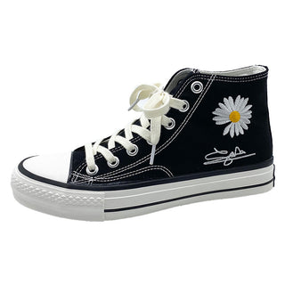 Trendy black and white women's high-top canvas sneakers with a large daisy flower design, perfect for casual wear and elevating one's style.