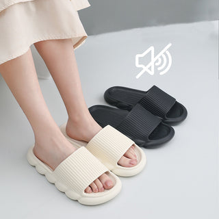 Comfortable home shoes: Two pairs of textured, slip-on slippers in contrasting black and cream colors, featuring non-slip soles and elevated designs for relaxation.