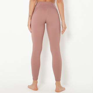 High-waist pink yoga pants with fitted, stretchy design against a white background.