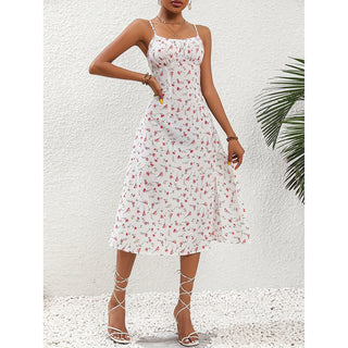 Elegant white summer dress with polka dot print, featuring a slit and suspender design. The image shows a stylish, feminine dress in a tropical setting with a palm tree in the background.