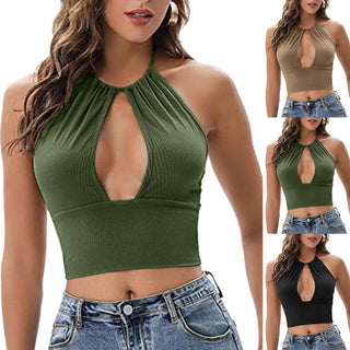 Sleeveless ribbed crop top with halter neckline in a deep forest green color, worn by a young woman with long wavy hair against a plain background.