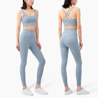 Stylish athletic outfit featuring gray sports bra and matching leggings from the K-AROLE™ fitness apparel collection. The sports bra has a criss-cross back design, and the leggings provide a sleek, form-fitting silhouette. This vibrant and comfortable athleisure ensemble is perfect for an active lifestyle and elevating one's fitness style.