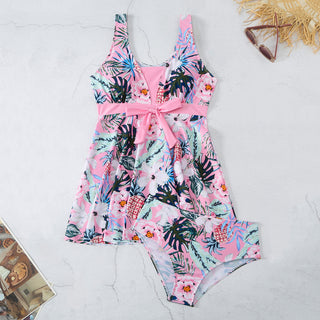 Vibrant tropical floral print women's V-neck split bikini swimsuit with fashionable design and chic accessories.