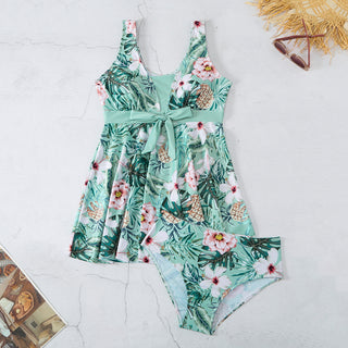 Tropical floral two-piece swimsuit with green leaves and colorful flowers