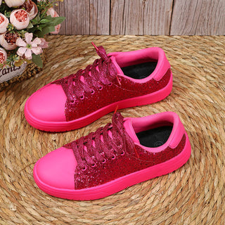 Vibrant pink glitter sequin sneakers with thick soles and lace-up design for stylish and comfortable casual wear.