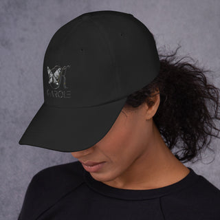 Stylish K-AROLE dad hat on model with curly dark hair against plain gray background