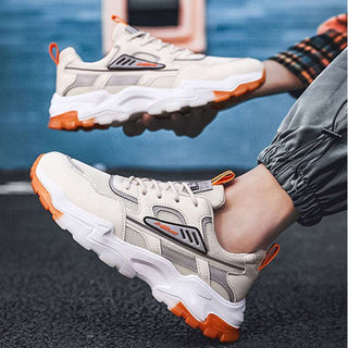 Trendy, comfortable sneakers with breathable mesh design and lace-up closure for active outdoor wear. Lightweight running shoes in a sleek white and orange color scheme.