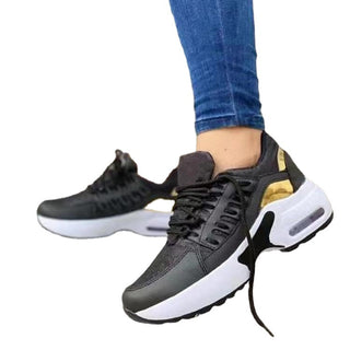 Stylish women's casual sneakers with a bold, sporty design. The black and white athletic shoes feature a comfortable, cushioned sole and a striking color-blocked upper, creating a modern, athleisure-inspired look.