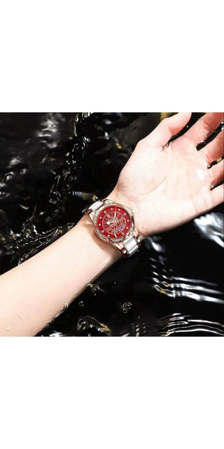 Elegant rose gold and red women's luxury watch with leather band. Delicate design featuring a stylish timepiece and decorative swan motif. The watch is displayed against a glossy black background, highlighting its premium quality and intricate details.
