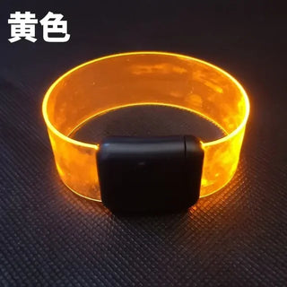Glowing yellow silicone sound-controlled flashing party bracelet with black activation module