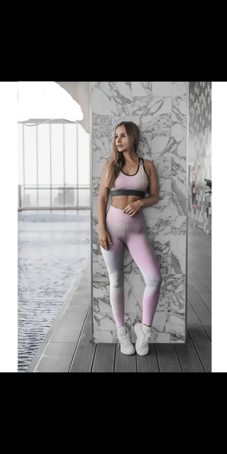 Comfortable athletic leggings with colorful crossing pattern, worn by a woman standing in a modern, marble-clad interior.
