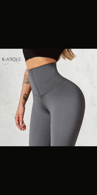 High-waisted grey sports leggings with a sleek, slim fit showcased on a female model.